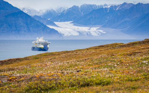 National Geographic Resolution sails an Arctic fjord on a Northwest Passage expedition cruise.