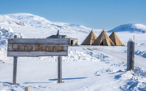 Camp Barentz with a backdrop of Snowy landscapes in the Artric during a landcruise