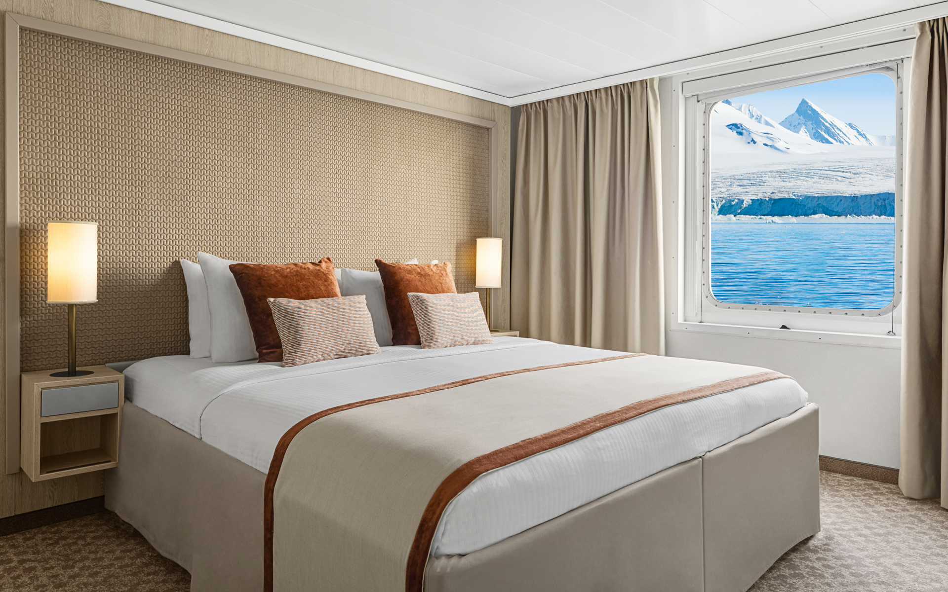 A large double bed and window are featured in this category 4 cabin with warm wood aboard the National Geographic Explorer