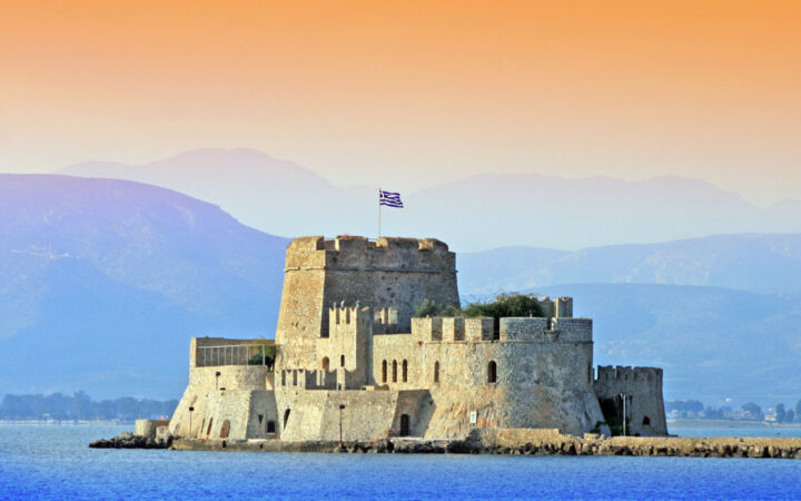 A view of greek architecture on an island in the antiquity to byzantium mediterranean cruise at sunset