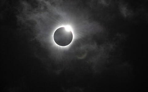 Black sky with black sun with white ring around it due to being fully eclipsed by the moon, seen on a Mediterranean cruise.
