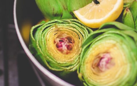 closeup of artichokes with a slide of lemon