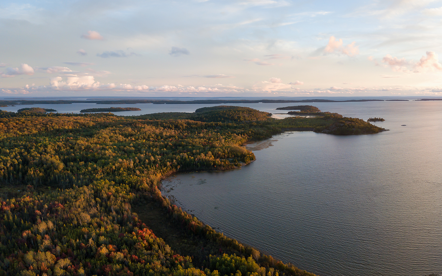 Aerial panoramic landscape view of a beautiful bay on the Great Lakes, Lake Huron, during a vibrant sunset.