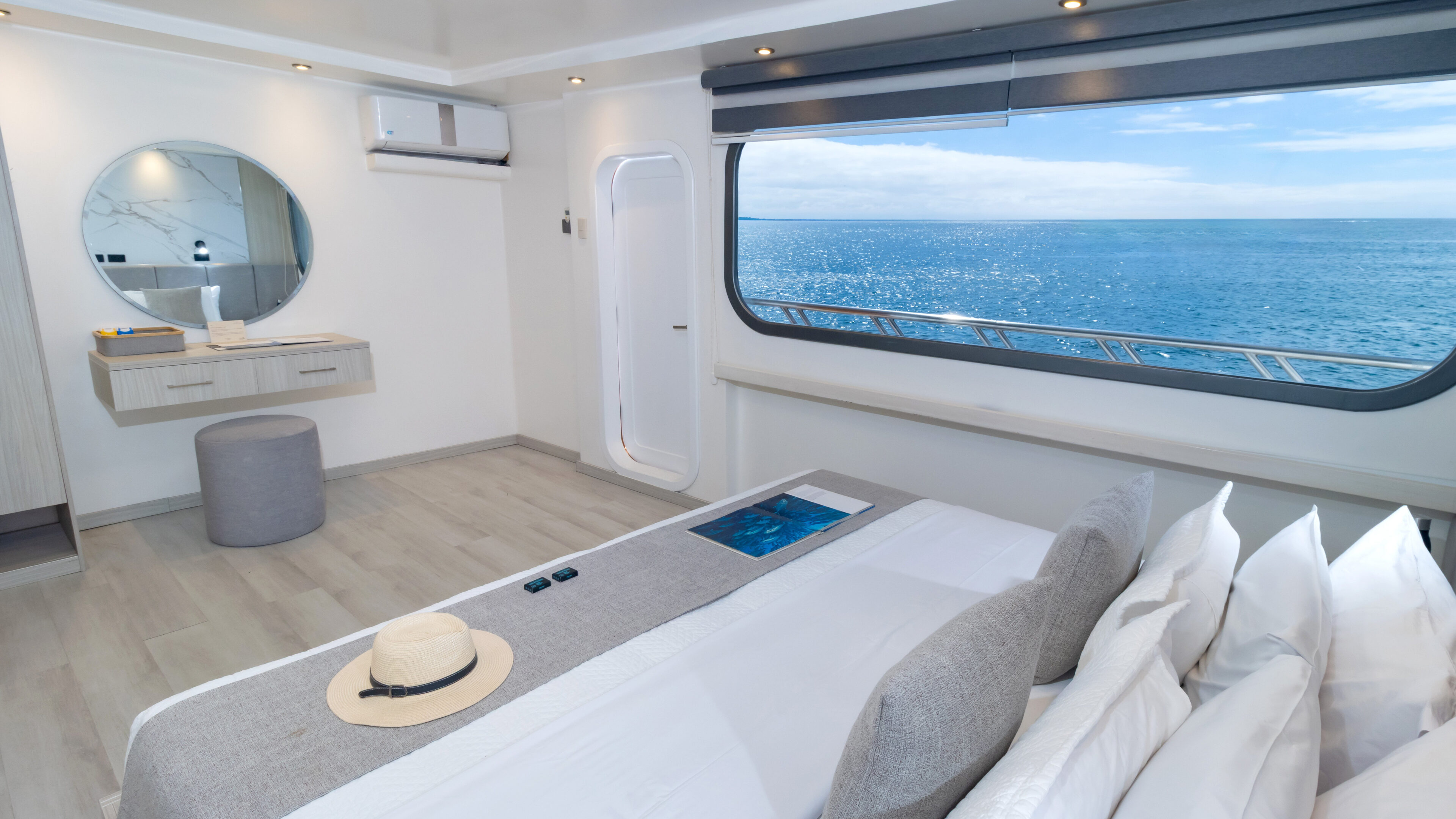 Stateroom with matrimonial bed and window aboard Galapagos Horizon