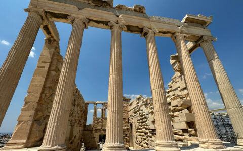 Ancient Greek ruins with beige columns holding crumbling stone, seen on the Greek Isles Odyssey cruise.