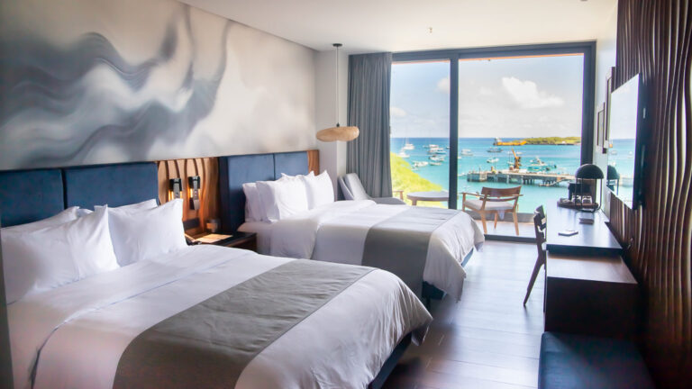 Suite hotel room at Hotel Indigo with king bed and sliding glass doors to a balcony