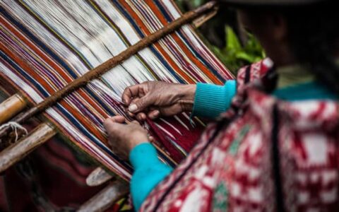 closeup of hands of woman weaving on sacred valley & lares adventure to machu picchu land tour