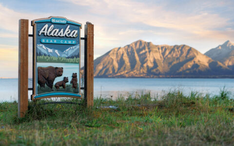 Alaska Bear camp sign overlooking the beautiful mountains of Alaska as the sun sets