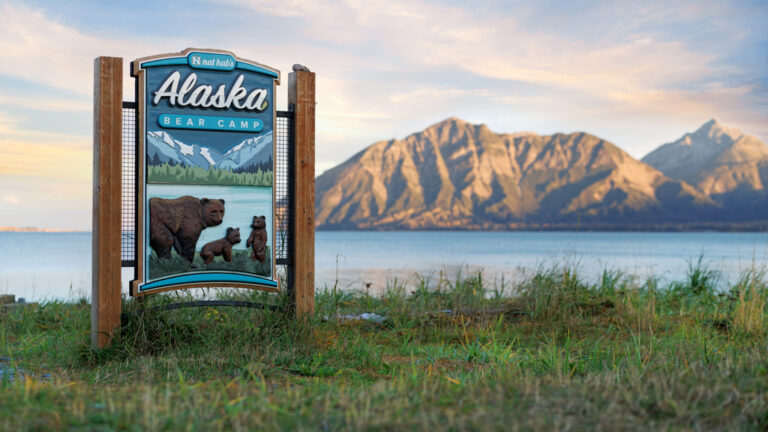 Alaska Bear camp sign overlooking the beautiful mountains of Alaska as the sun sets