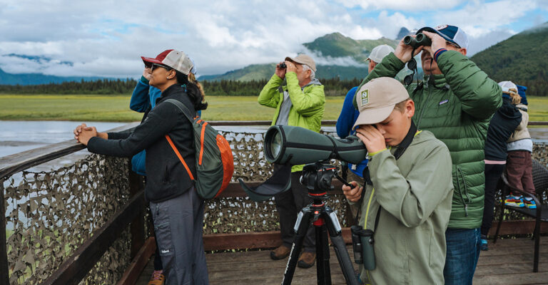 Guests enjoy a look out view of bears in Alaska at the Alaska Bear Camp