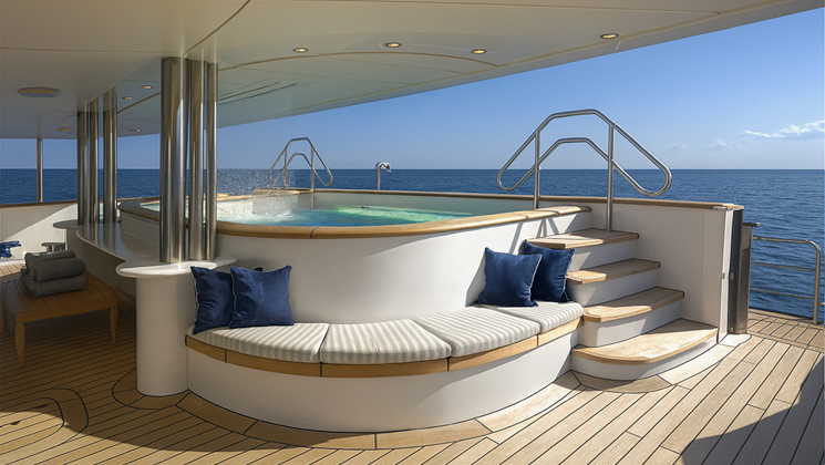 Aft outdoor Jacuzzi on Aqua Lares ship in Africa with teak deck, blue & white bench, sun shade & ocean views.