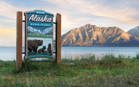Alaska Bear camp sign overlooking the beautiful mountains of Alaska as the sun sets