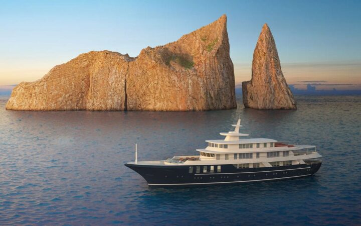 Rendering of Conservation Galapagos yacht with dark blue hull & white upper decks sitting beside large beige rocks at sunset.