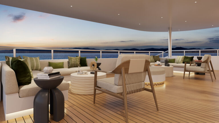 Outdoor seating aboard grand ocean spray with modern comfortable seating looking out at the sunsetting over Galapagos