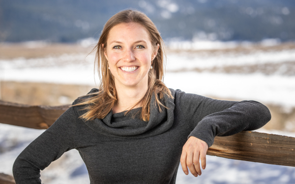 Adventuresmith expert Lauren smiling on a sunny day with her hair down and earrings on