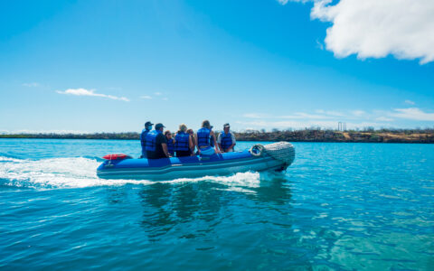 Panga cruising through open waters of Galapagos headed back to small ship Grand Ocean Spray