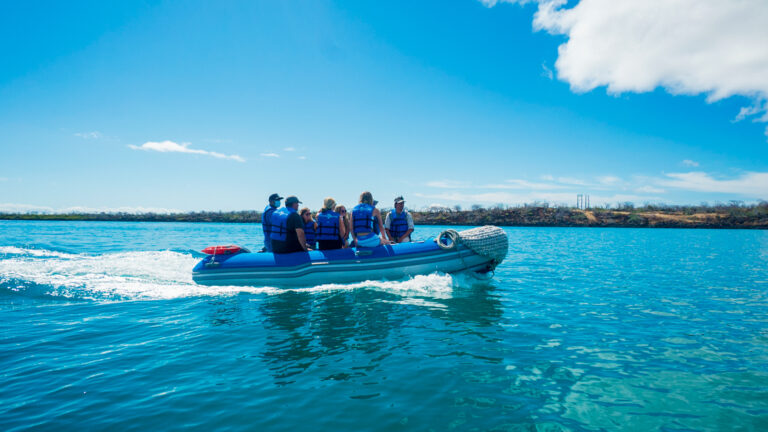Panga cruising through open waters of Galapagos headed back to small ship Grand Ocean Spray