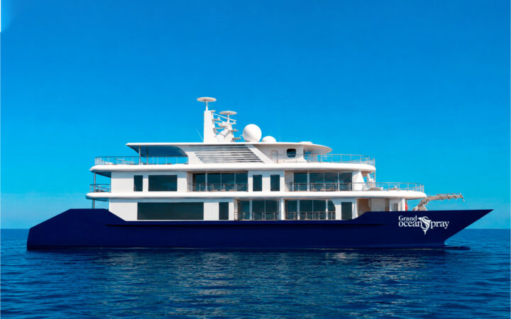 Rendering of starboard side of small ship Grand Ocean Spray with blue hull & white upper decks, cruising through open waters in the Galapagos.
