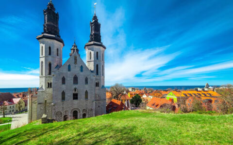 Old church in Visby, Gotland, Sweden standing tall next to a nice large lawn of grass