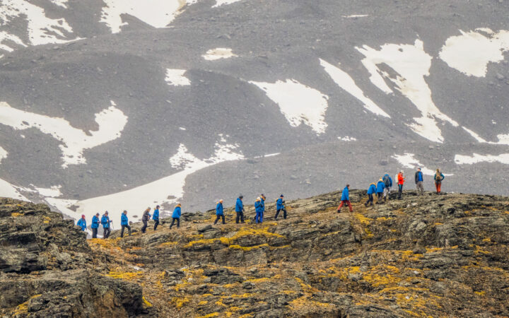 Guests hiking in Signehamna, Svalbard during Svalbard, Iceland & Greenland’s East Coast Cruise.