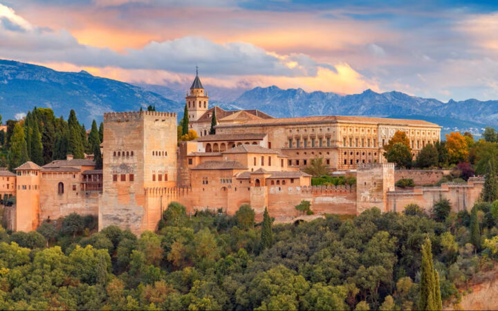elevated view of the Alhambra palace and fortress complex in Granada, Spain, at sunset. evated view of the Alhambra palace and fortress complex in Granada, Spain, at sunset.