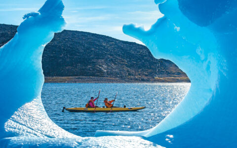 Kayaker framed by Iceberg, Arctic Harbour, Baffin Bay, Baffin Island, Arctic Canada
