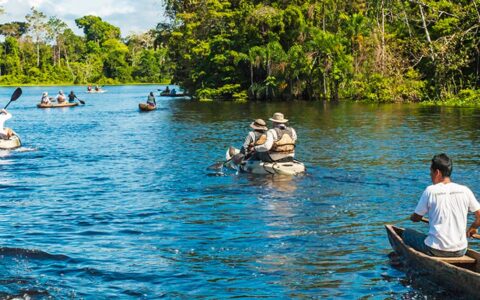 Two people kayaking on river in the Peruvian Amazon