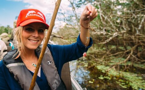 Woman holding baited hook while fishing for piranha