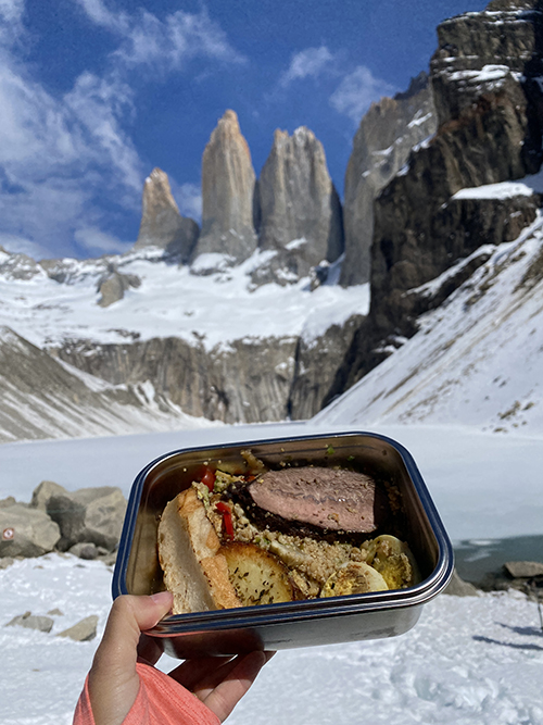 A packed lunch in a steel lunchbox from EcoCamp seen beneath the Towers