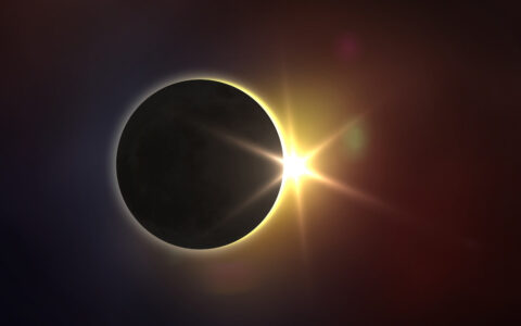 Solar eclipse nearing totality with sun barely peeking out around a black moon, seen on the Total Eclipse & Greenland cruise.