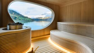 Sauna aboard Le Champlain french ship, with long wooden bench, heated rocks & window.