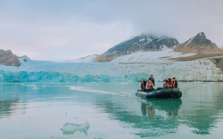 In North Spitsbergen we see a zodiac returning from an excursion to see a glacier