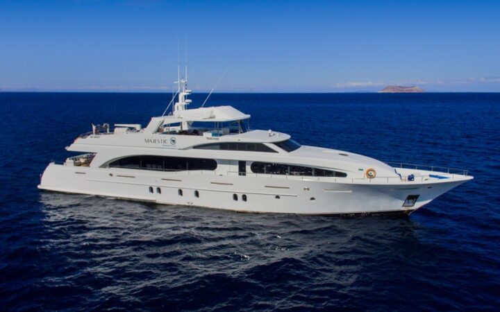 Aerial view of Grand Majestic motor yacht with 3 decks, white fiberglass hull & private yacht look.