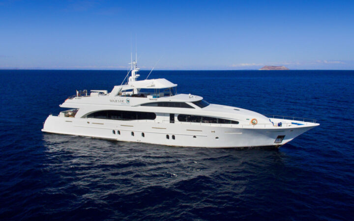 Aerial view of Grand Majestic motor yacht with 3 decks, white fiberglass hull & private yacht look.