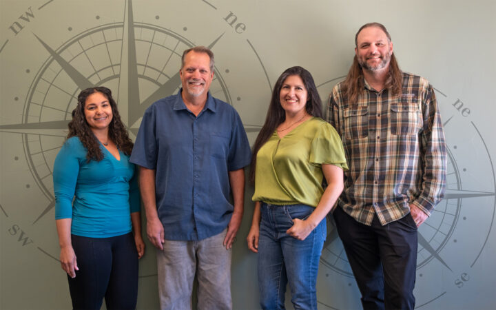 Four AdventureSmith Explorations experts pose together for group photo after winning Condé Nast Top Travel specialist awards