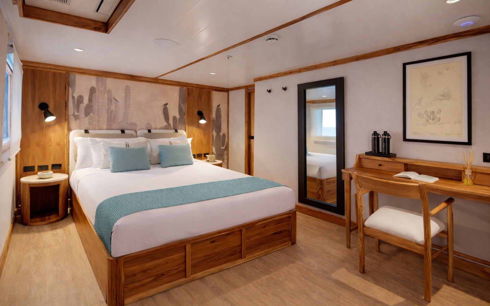 Small ship Evolution's Albatross Deck Suite with a double bed, desk, body-length mirror, window, and light blue accent linens.