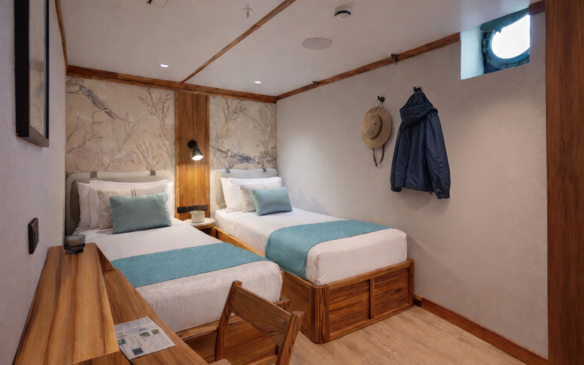 Small ship Evolution's Deluxe Stateroom with two twin beds, a desk, window, and white linens with light blue accents.