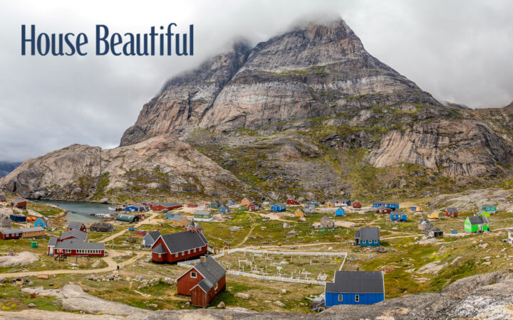 airel view of greenland town with large mountain on a cloudy day with colorful buildings and houses with a house beautiful logo