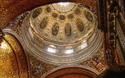 looking up at the inside of an ornate basilica dome on the quito and guayaquil galapagos land tour