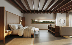 Spacious Evolution Suite at Finch Bay Galapagos hotel with king bed in white linens, modern aesthetics, couch & panoramic windows.