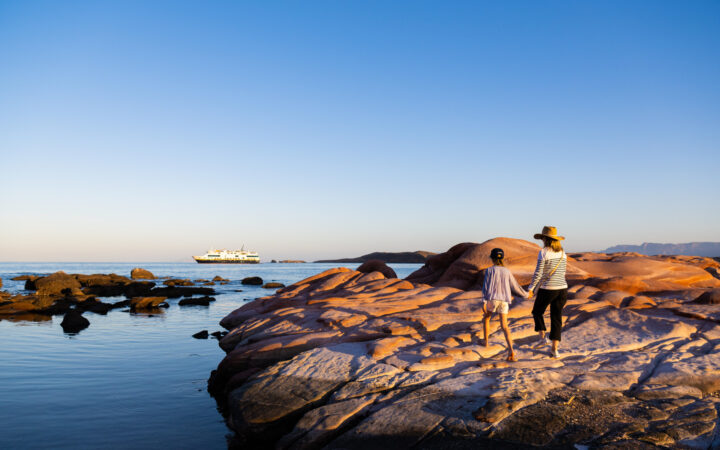 Two guests enjoy a day of hiking in Puerto Los Gatos, Baja California Sur, Mexico on a calm sunny day