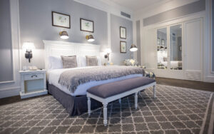 King bed with reading lamps and bedside tables inside Park Suite at Hotel del Parque in Guayaquil, Ecuador
