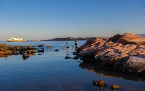 Guests explore by standup paddleboard from the ship National Geographic Venture in Puerto Los Gatos, Baja California Sur, Mexico