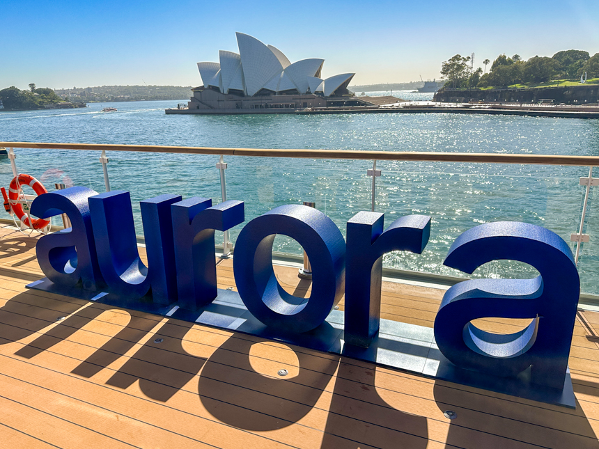 Aurora expeditions name in big block letters on the deck of Douglas Mawson overlooking the Orpah house in the Sydney harbor  