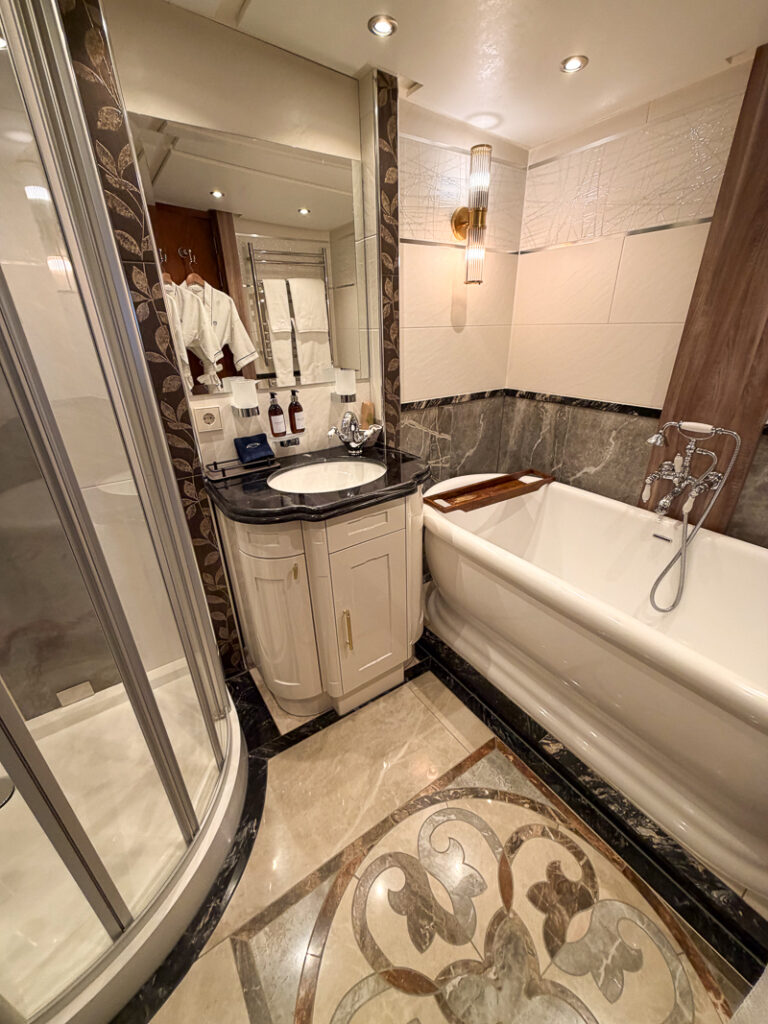 marble bathroom inside owner suite aboard Aqua Lares, separate tub and shower, heated floors and towel rack. 
