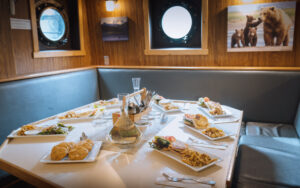 Dining table and bar area aboard Ursus.