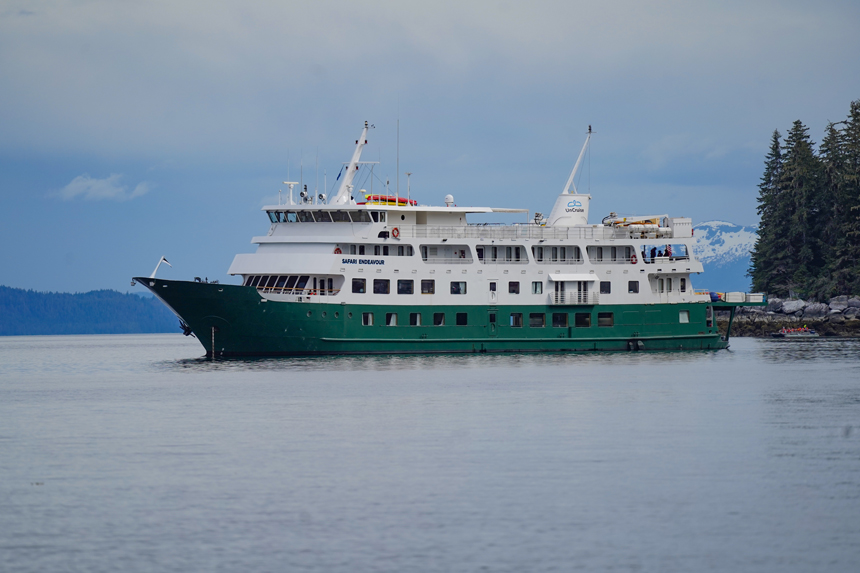 Safari Endeavour small expedition ship charter cruising on glassy Alaskan waters on a sunny day.